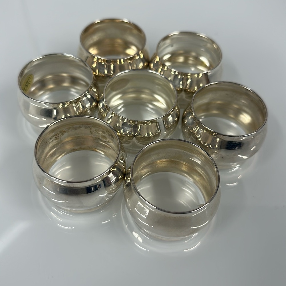 Set of 7 silver toned napkin rings